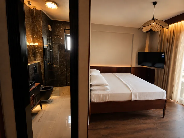 Room and marble en-suite bathroom at Lusso boutique hotel, Prishtina